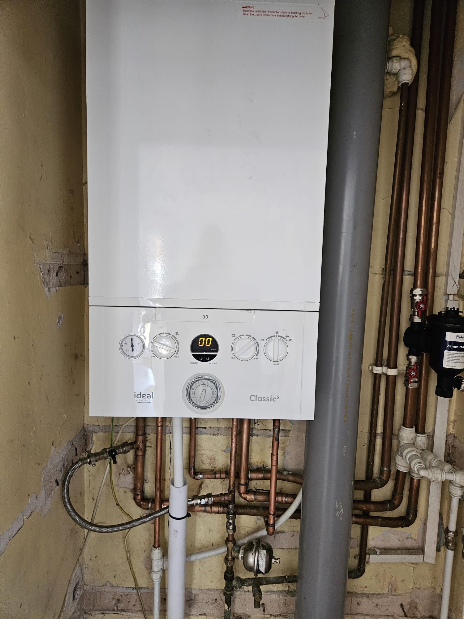 Little Plumb engineer servicing a domestic boiler in Torquay