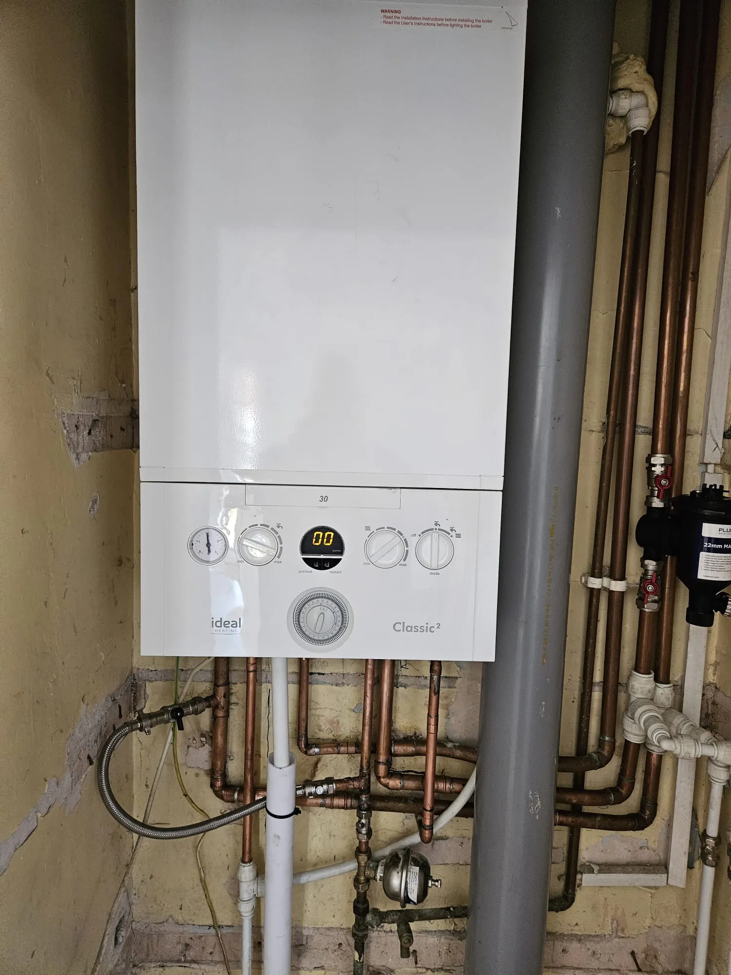 Little Plumb engineer servicing a domestic boiler in Torquay